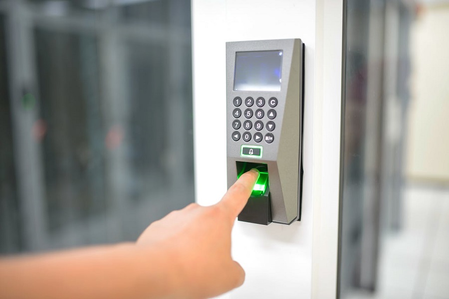 Person scaning fingerprint to access secure facility