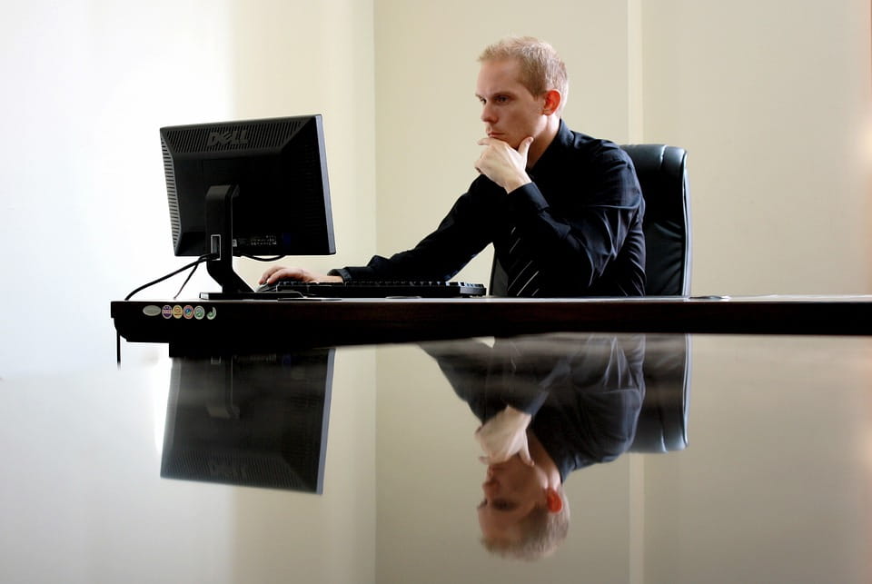 business-man-looking-at-pc-monitor-contemplating