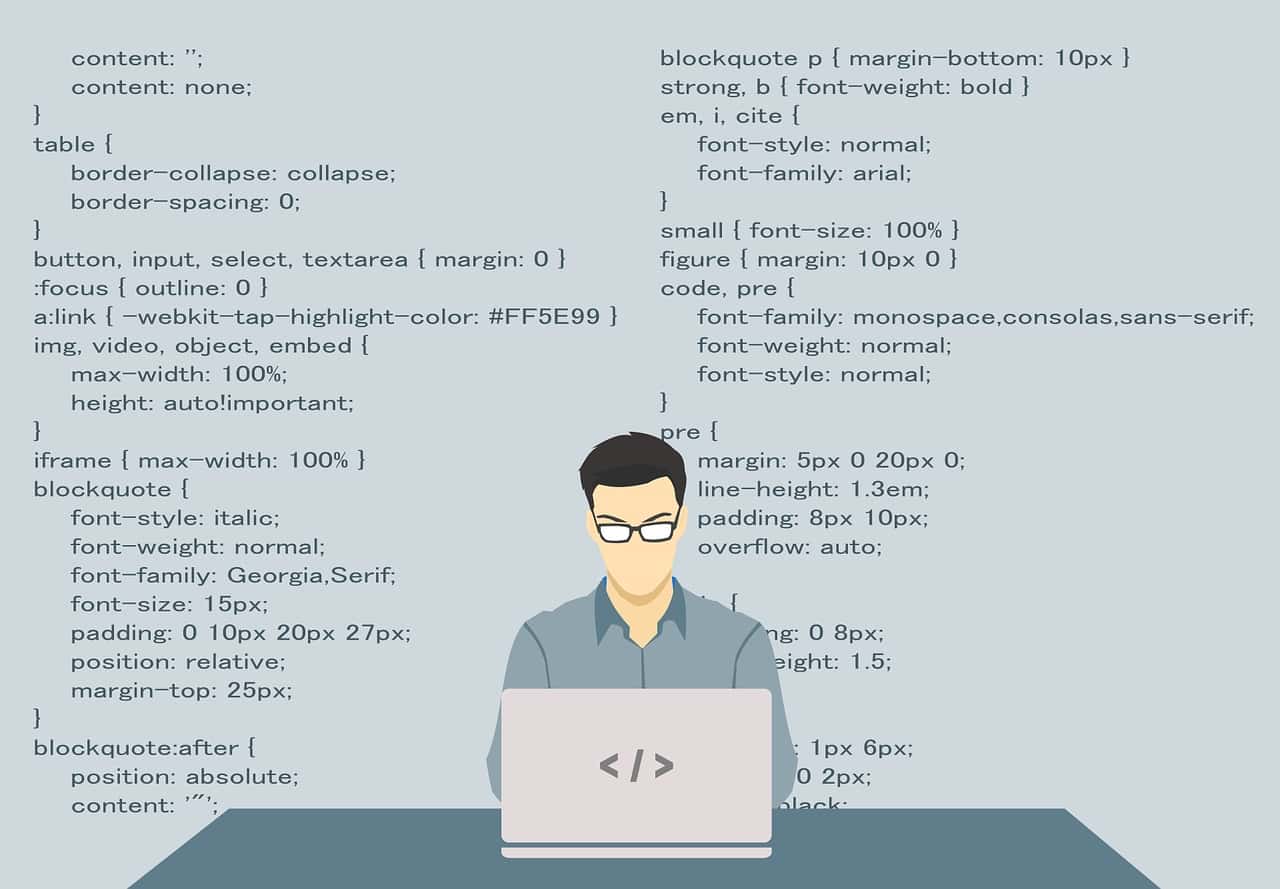 Programmer Using Laptop with code in the background